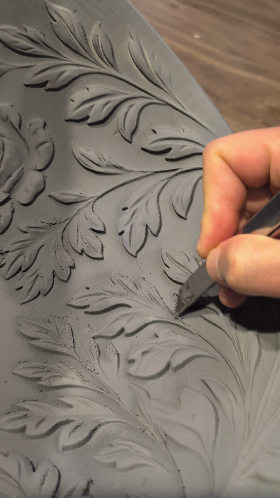 Hand cleaning up the carved rose and acanthus relief with a detail knife
